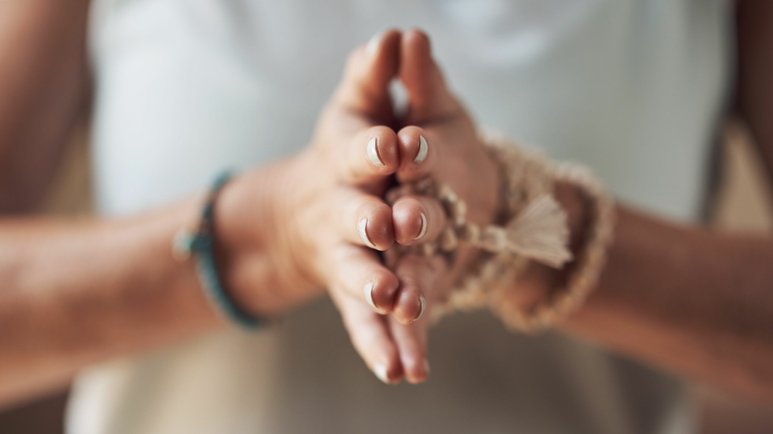 A photo of a woman with her palms together