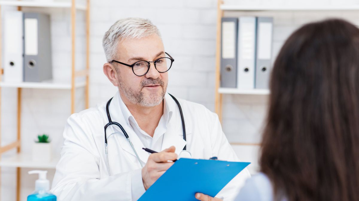 A photo of a general practitioner talking to his patient